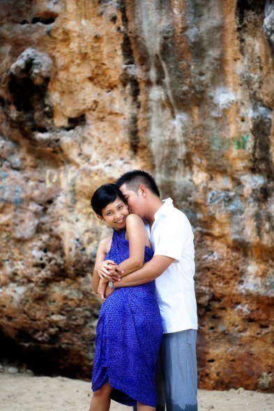 Bunn Salarzon - guy and girl hugging against rock at beach