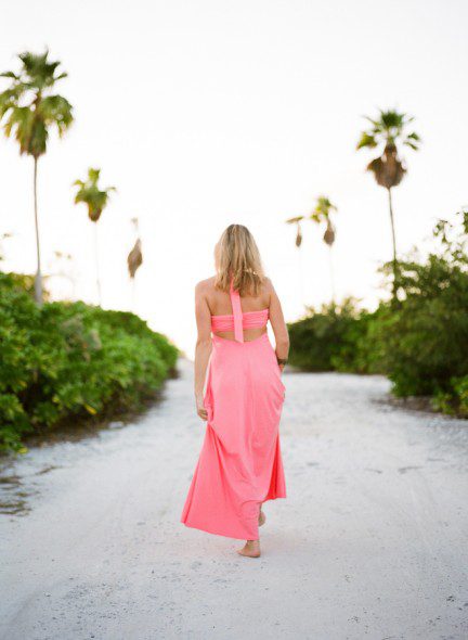 Bunn Salarzon - woman in pretty pink dress walking on the beach