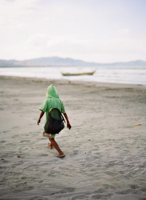 Bunn Salarzon - young fisherman walking on the beach