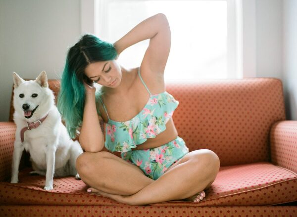 Bunn Salarzon - beautiful woman sitting on sofa with white dog
