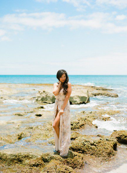 Bunn Salarzon - gorgeous woman standing on rocky beach in hawaii