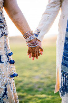 Bunn Salarzon - indian wedding bride and groom holding hands